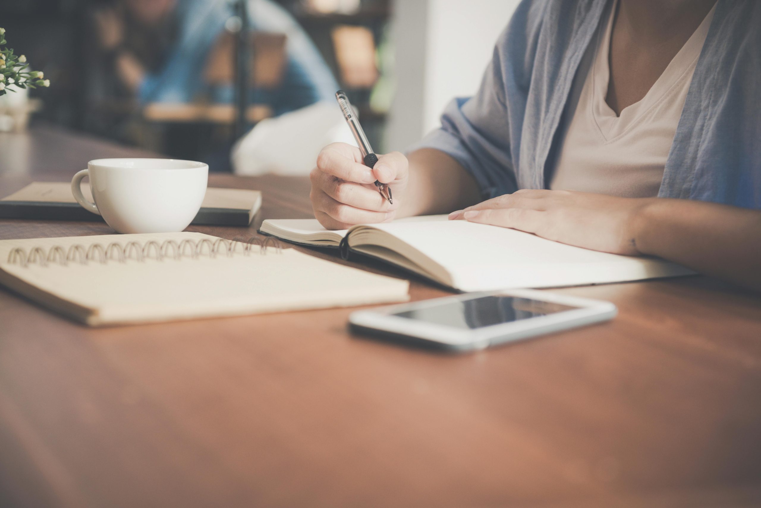 A person writing text on a book