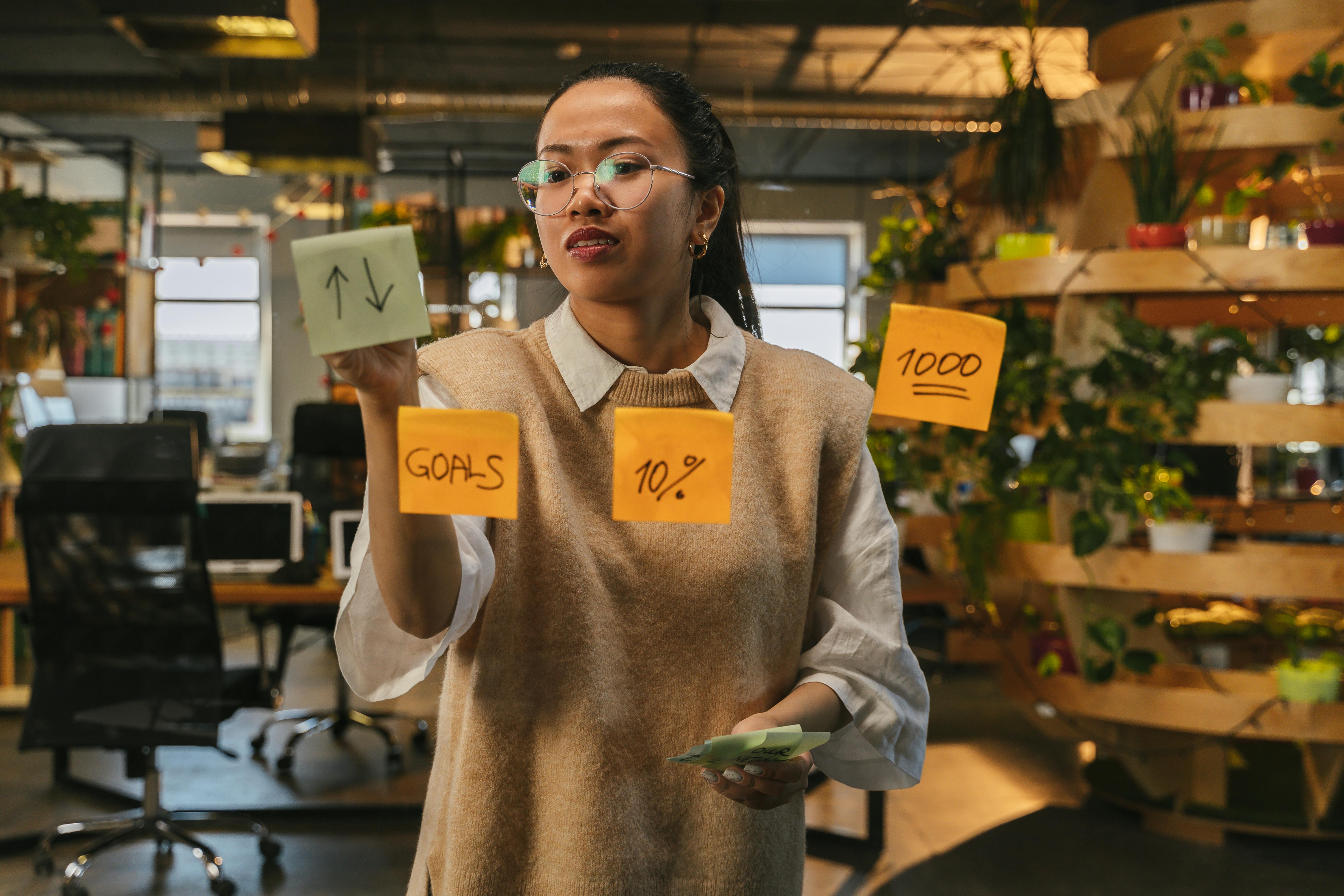A women writing on sticky notes